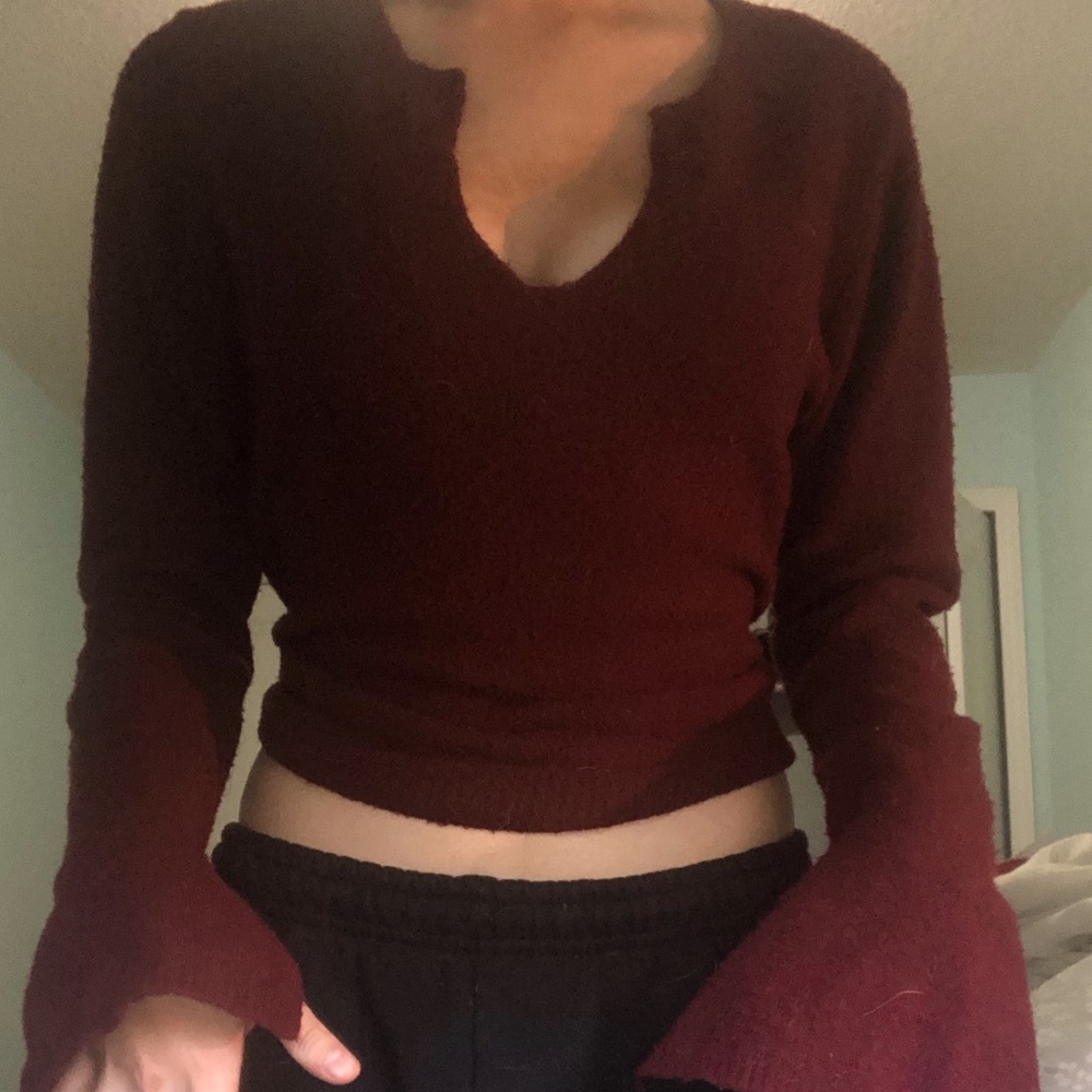burgundy low cut long sleeved top with bell sleeves
